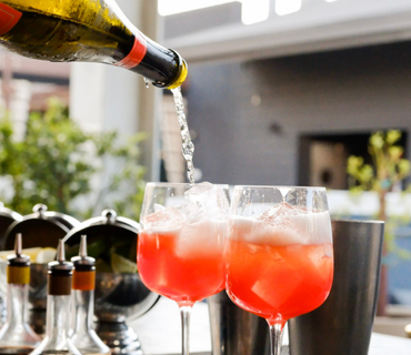 Two aperols spritz being made at a bar in Hollywood for an Amalfi Reserve Event.
