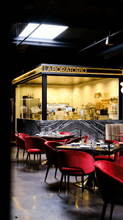 Pasta Laboratorio at WeVINO Westlake Village in California with elegant red chairs and table settings.